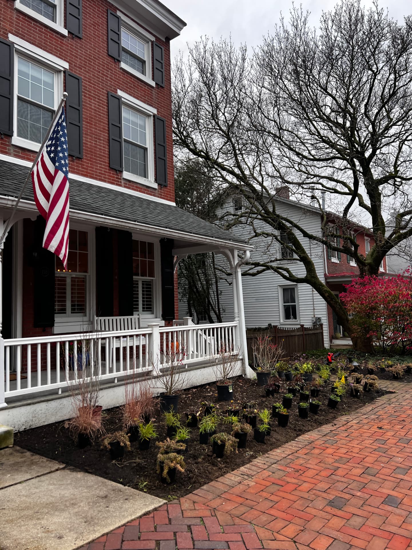 Before: angled view of the townhome porch and newly prepared front garden beds