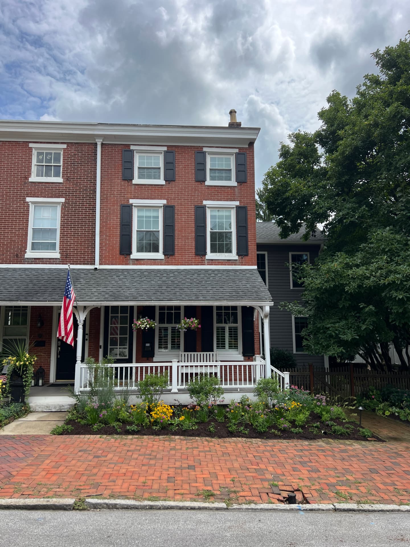 After: straight-on view of the West Chester townhome framed by the mature front garden