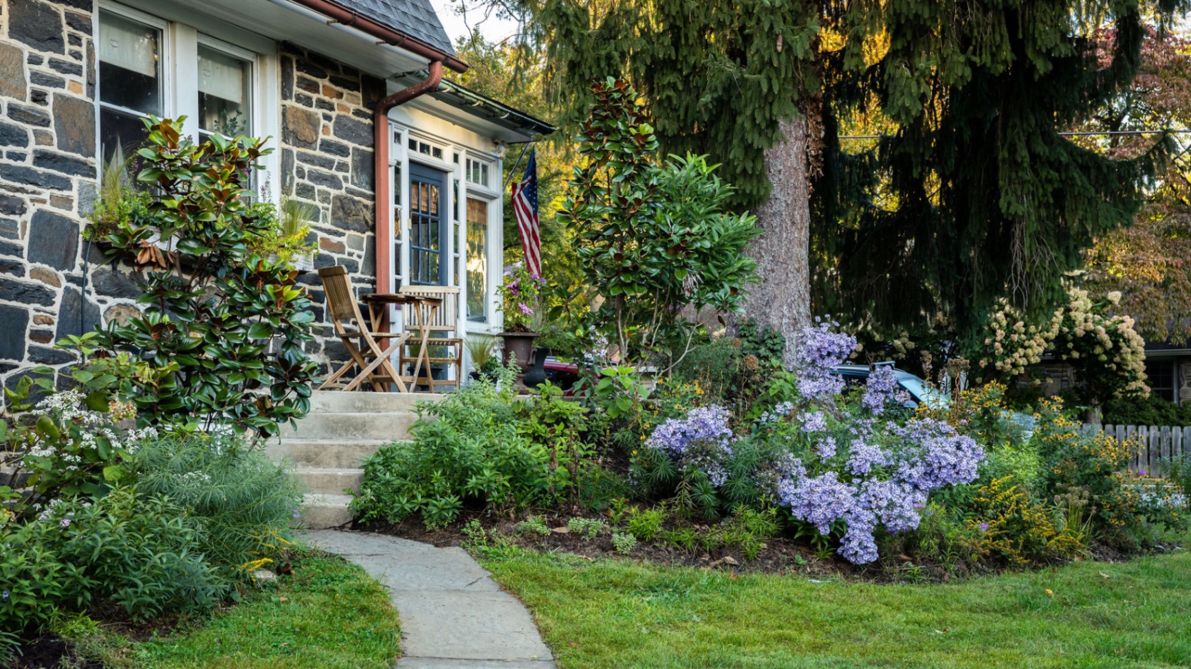 Flagstone path to the stone porch through blue asters, magnolia, and goldenrod