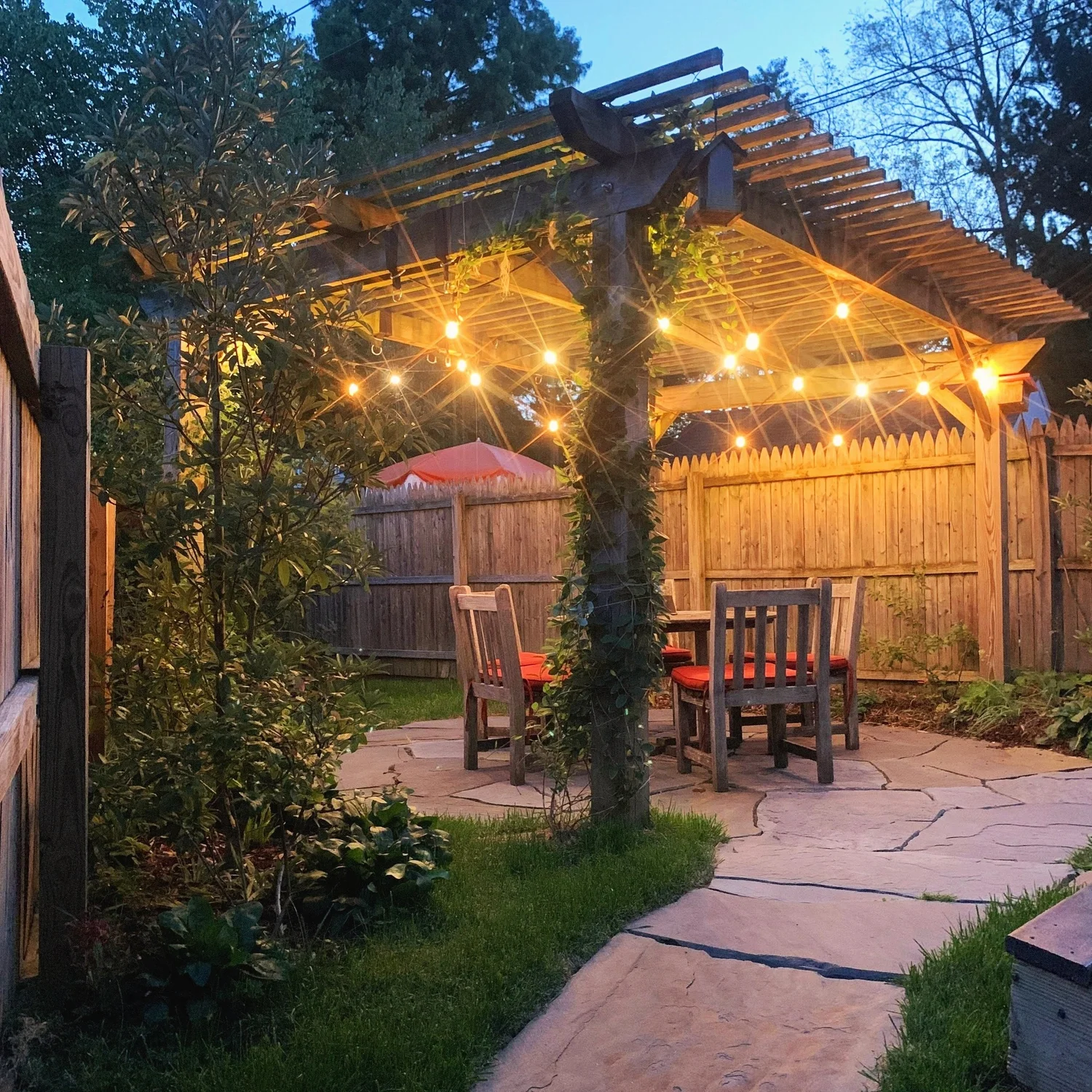 Bluestone path leading to a patio and dining table in a Merion Station rear yard at dusk